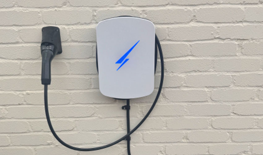 Wall-mounted EV charger on painted exterior