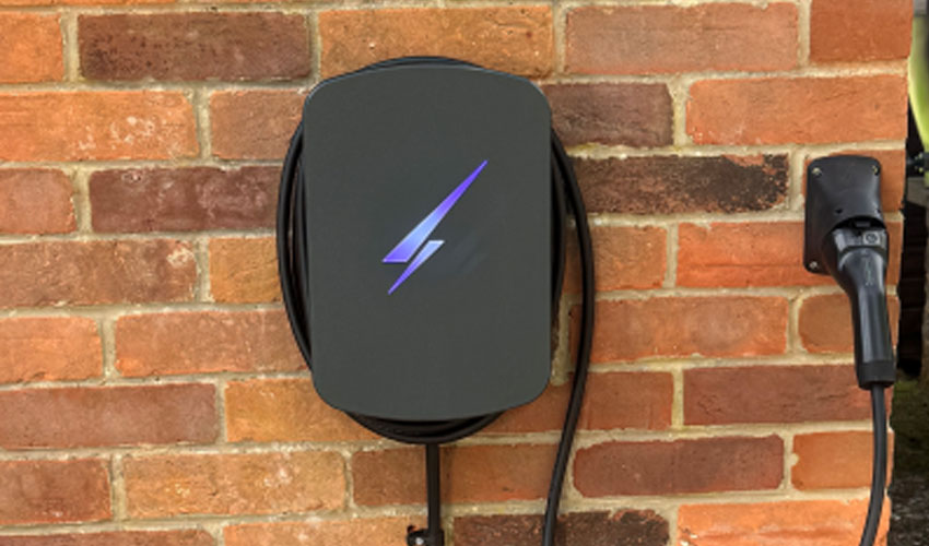 Domestic EV charger installation on brick exterior